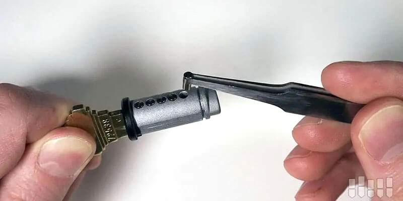 Locksmith rekeying a deadbolt cylinder with new pins at a Las Vegas home