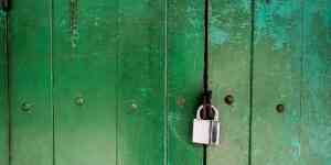Bolt cutters positioned on a padlock shackle at a Las Vegas gate