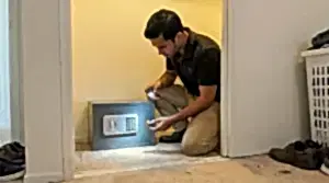 24/7 Locksmith 4U LV technician checking the keypad battery on a locked home safe in a Las Vegas condo closet